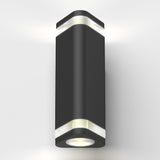 A modern, black, cylindrical wall light fixture with white frosted accents, emitting light from both the top and bottom, mounted on a plain white wall.