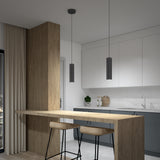 Modern kitchen with minimalist design featuring a wooden breakfast bar, two bar stools, pendant lights, white cabinets, gray lower cabinets, and a marble backsplash. Neutral tones and clean lines create a sleek look.