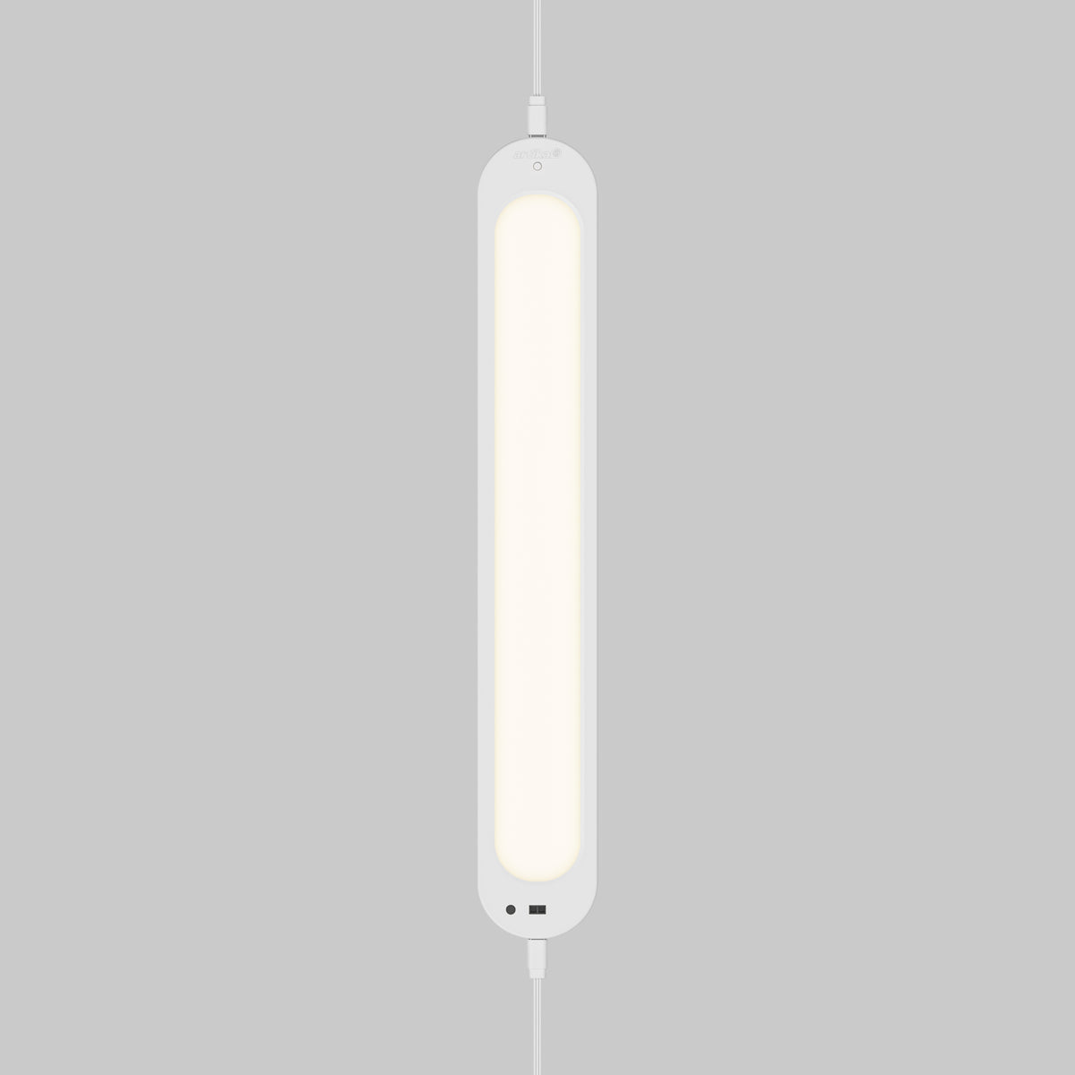 The Artika Impulse Under-Cabinet LED Light RGB+CCT with Remote glows softly, hanging vertically against a plain grey background.