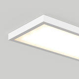 A rectangular, white, ceiling-mounted LED light fixture illuminated against a plain light gray ceiling.