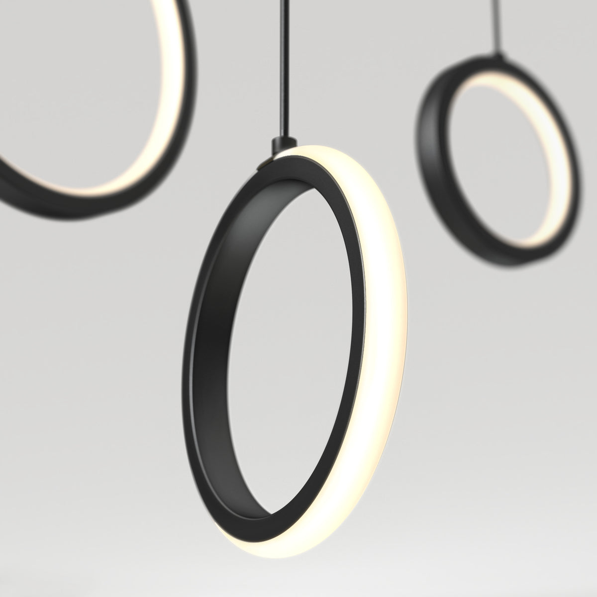 The Artika Elmo 5-light LED pendant features modern circular black frames with glowing white edges, suspended against a light grey background. Its minimal, contemporary design offers versatile style with 5 CCT settings.