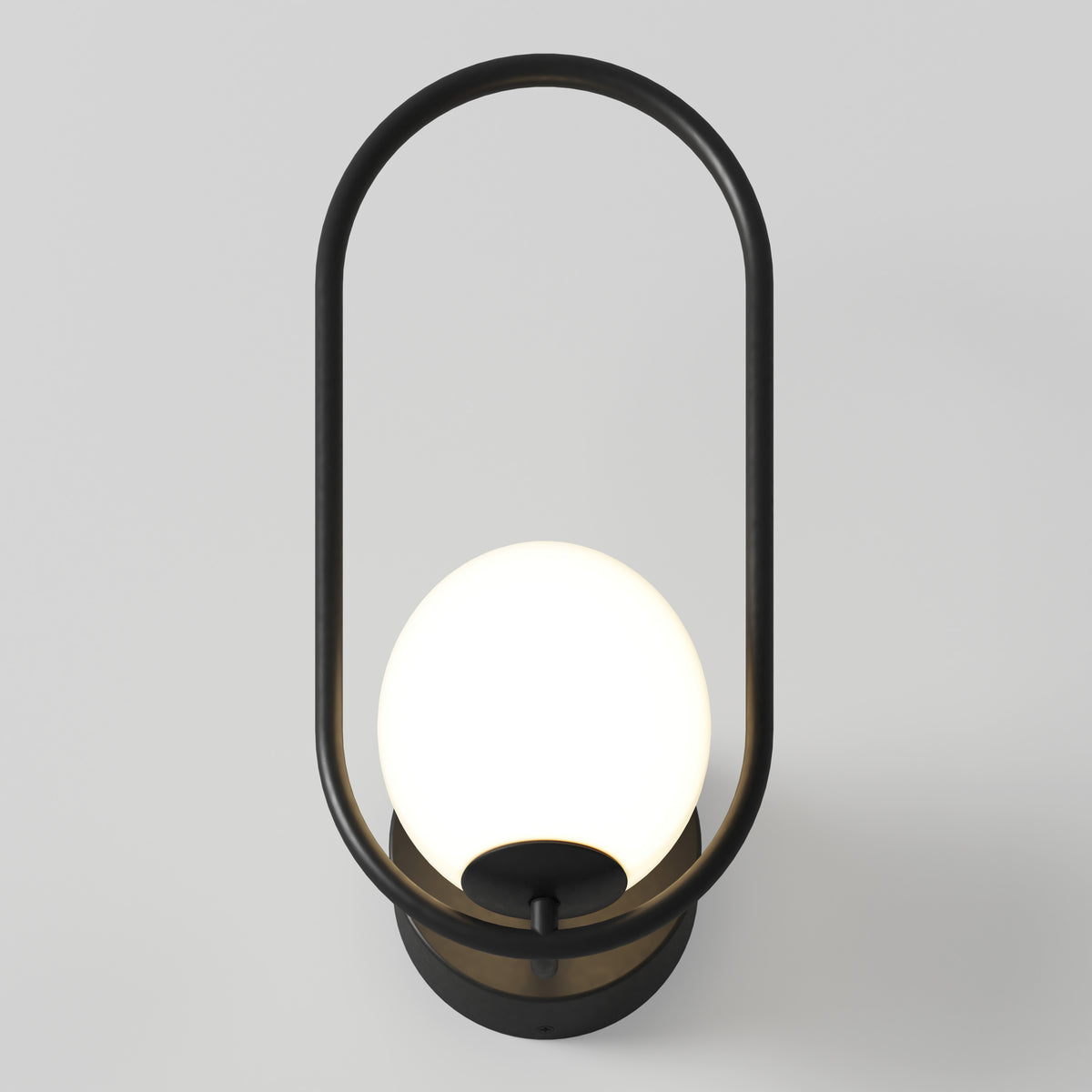 The Artika Bloom LED Sconce 3 CCT features a black oval frame around a glowing white globe, mounted on a round black base, shown against a plain light gray background.