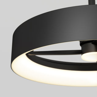 Close-up of the Artika Austin 23 in. LED modern ceiling fan with remote, showcasing its minimalist black circular design and glowing white inner ring against a light gray background.