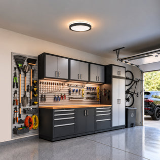 Artika Callisto 15 in. (38 cm) Modern LED Flush Mount Ceiling Light 5 CCT installed in a garage with organized wall-mounted tools and cabinetry.