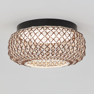 The Artika Benson 15 in. LED flush mount light features a woven rattan shade with a crisscross pattern and a black circular base, providing stylish illumination for any light-colored ceiling.