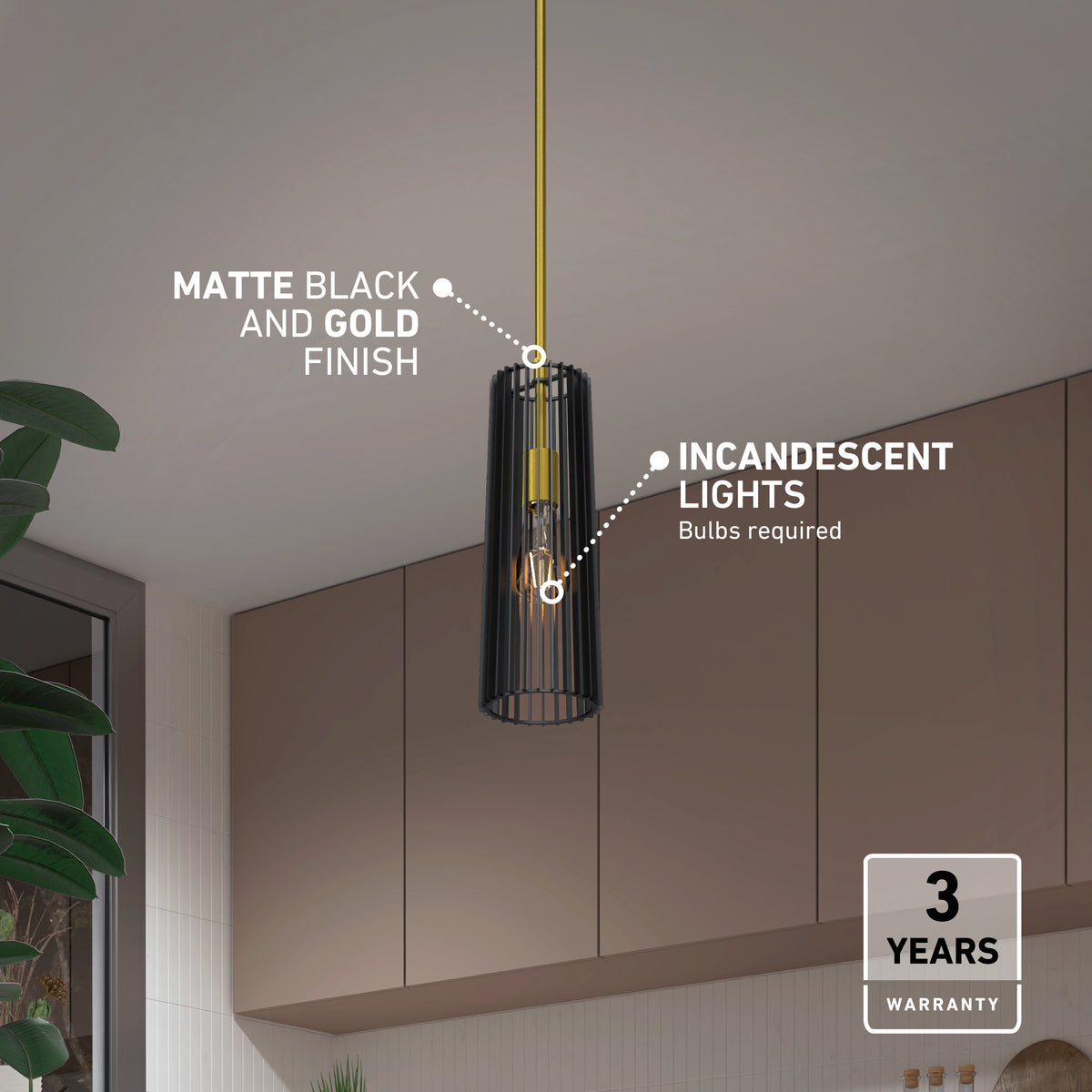 A matte black and gold hanging pendant light with an exposed incandescent bulb, set in a modern kitchen with brown cabinets and a plant. 3 years warranty badge appears in the bottom right corner.