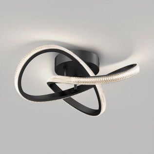 The Artika Morgan modern LED flush mount light 5 CCT features intertwined black loops with embedded LEDs, creating a sculptural, abstract design that stands out against a plain gray background.