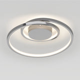 A modern, circular ceiling light fixture with a sleek chrome finish and an integrated LED ring emitting a soft, even glow. The light features a spiral design and is mounted on a plain white ceiling.