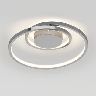 The Artika Salto LED flush mount light features a circular spiral design in metallic silver, providing a soft, even glow on a plain white ceiling.