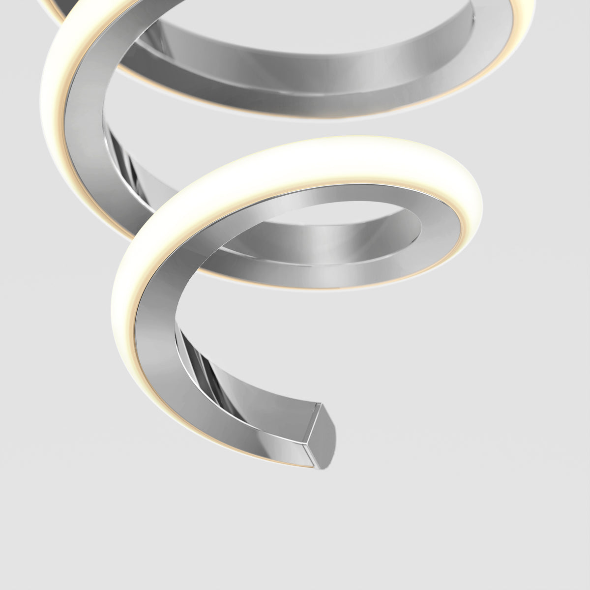A close-up of the Artika Chorus 1-light LED pendant 5 CCT, a modern spiral fixture with a shiny metallic finish and glowing white edges, set against a plain light gray background.