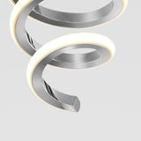 A close-up of a modern, metallic spiral light fixture with a glowing white edge, set against a plain light gray background.