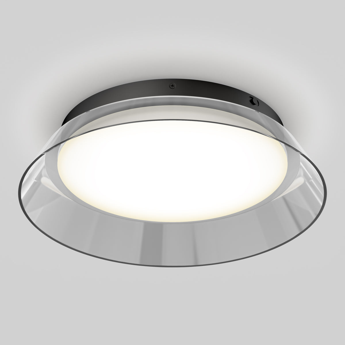A modern round ceiling light fixture with a black base, wide frosted glass cover, and a clear outer rim, emitting a soft white glow against a light gray background.