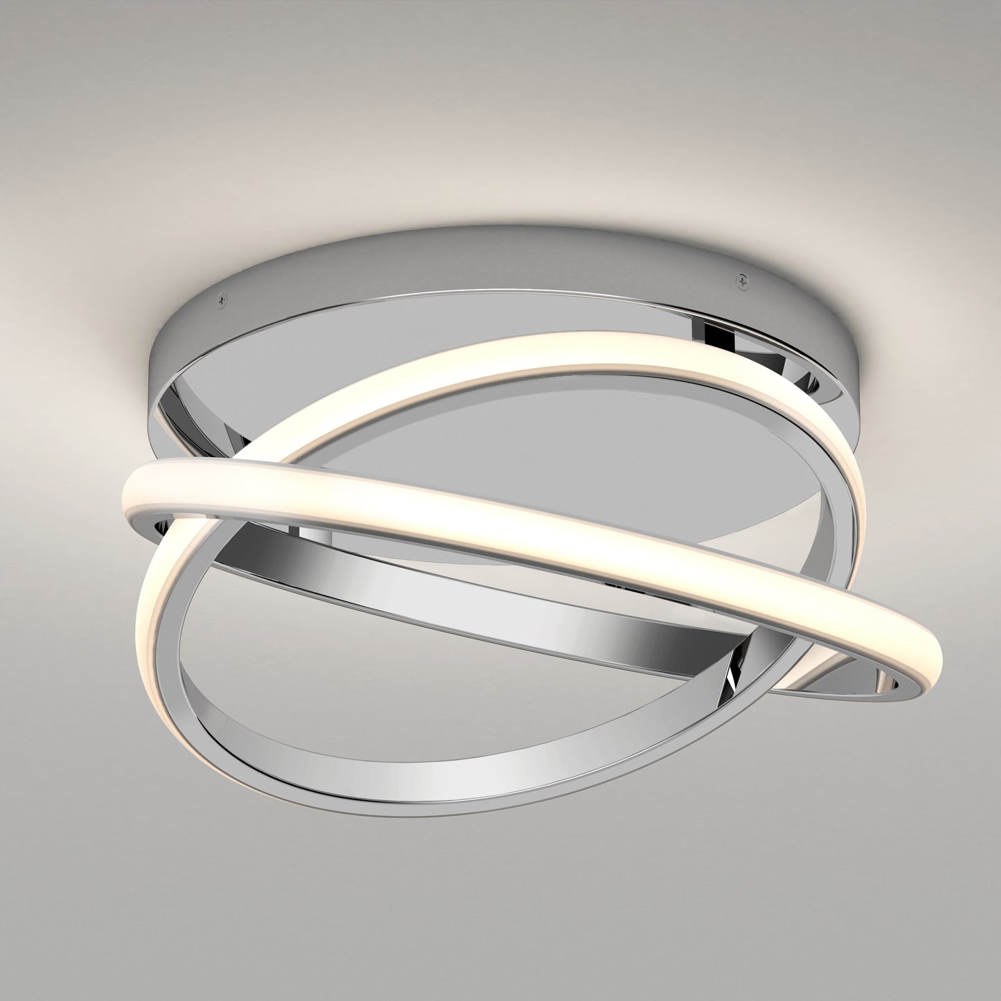 The Artika Orbia modern LED flush mount light features a round chrome base with two intertwined rings—one illuminated, one metallic—for a contemporary, sculptural design against a light gray ceiling. Offers 3 selectable color temperatures.