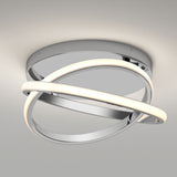 A modern ceiling light fixture with two intersecting chrome rings, one emitting a soft white glow, mounted on a round metallic base against a plain ceiling.