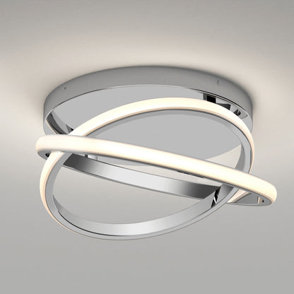 The Artika Orbia modern LED flush mount light features a round chrome base with two intertwined rings—one illuminated, one metallic—for a contemporary, sculptural design against a light gray ceiling. Offers 3 selectable color temperatures.