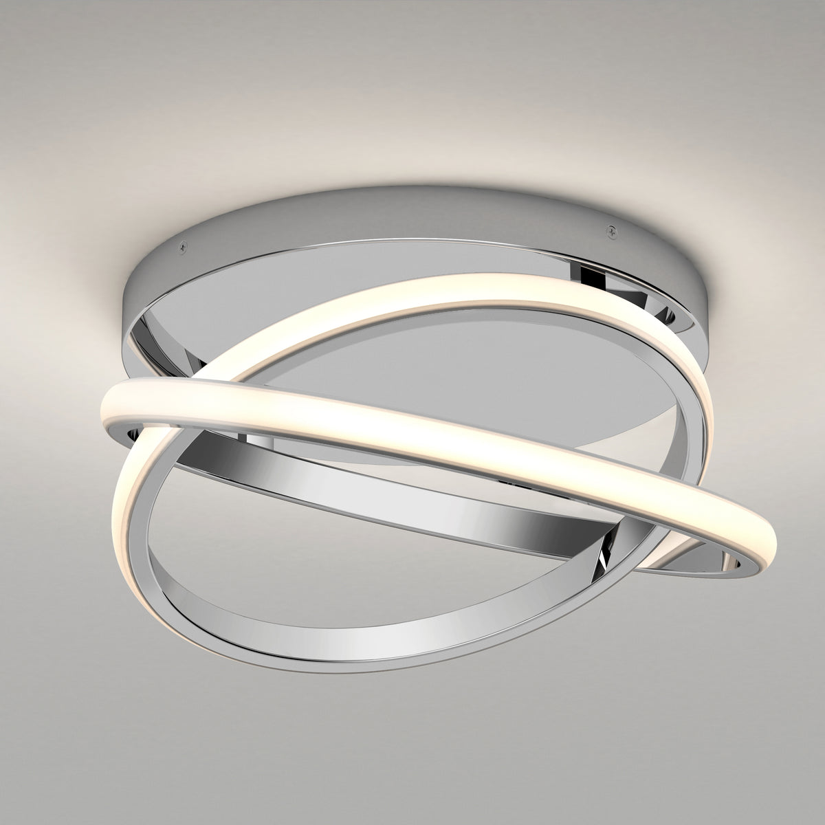 The Artika Orbia modern LED flush mount light 3 CCT features a chrome base with two intersecting, curved LED strips—one lit, one reflective—for a sleek, contemporary look.
