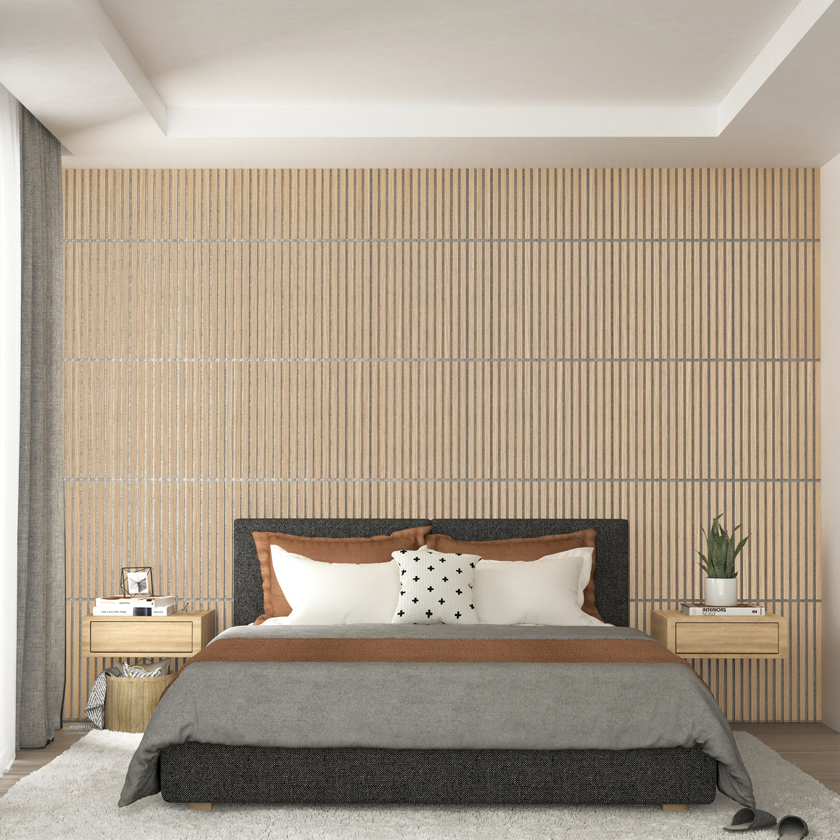 A modern bedroom with a wood-paneled accent wall, a bed with white, brown, and gray bedding, two matching wood nightstands, a potted plant, and decorative items beside a large curtained window.