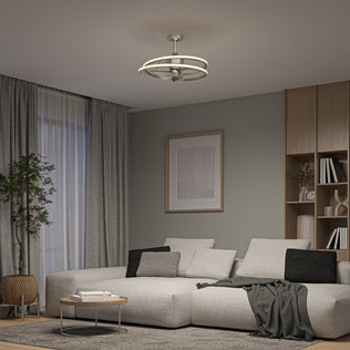 Modern living room with a light gray sectional, round coffee table, wall art, bookshelves, and Artika's Coda 23 in. LED ceiling fan.