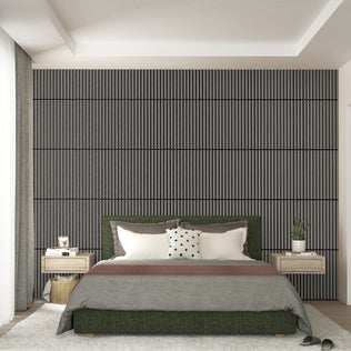 A modern bedroom features a large bed, two floating nightstands with lamps, and an Artika Sonolok 15.5 ft sound-absorbing wall panel kit (4-pack) as a textured accent wall with vertical lines behind the bed. Slippers rest near the bed.
