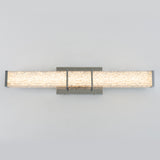 Rectangular modern wall sconce with a textured, illuminated glass or acrylic panel and metallic end caps, mounted on a matching rectangular backplate against a light gray background.