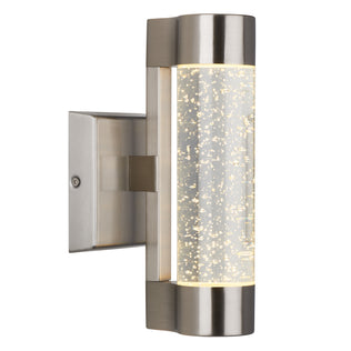 The Artika Bubble Element LED indoor-outdoor light features a modern design with a brushed metal finish and a cylindrical acrylic shade accented by bubble details, casting a soft, warm glow.