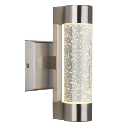 The Artika Bubble Element LED indoor-outdoor light features a modern design with a brushed metal finish and a cylindrical acrylic shade accented by bubble details, casting a soft, warm glow.
