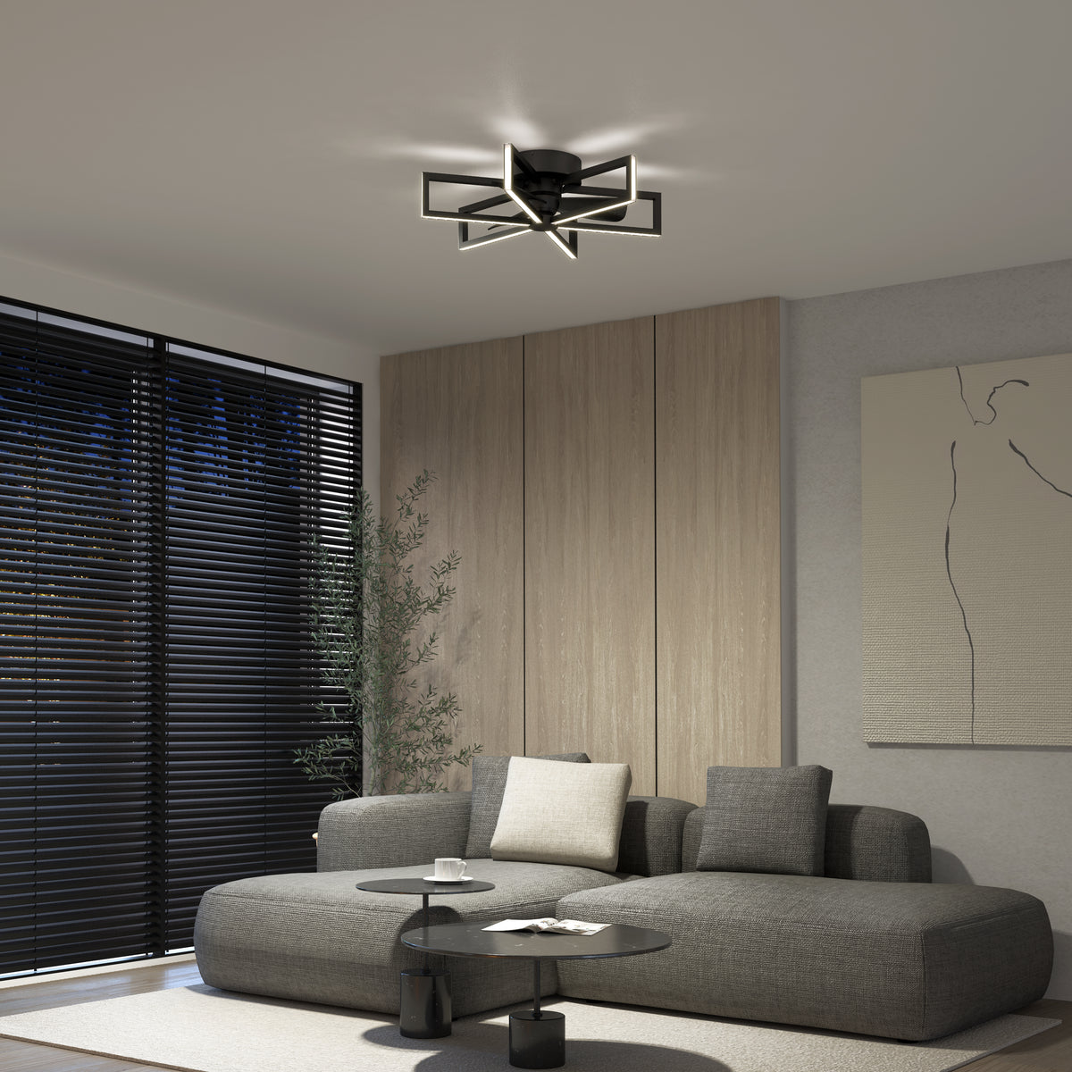 Modern living room with a gray sectional sofa, round black coffee tables, minimalist wall art, vertical wood paneling, and a geometric black ceiling light fixture; large window with dark blinds and a tall plant in the corner.