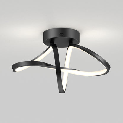 The Artika Loop modern LED flush mount light features black, ribbon-like LED strips in a twisting design on a round black base, creating a contemporary look against a light gray ceiling. Offers 3 CCT options for versatile lighting.