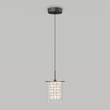 A modern pendant light fixture with a black circular ceiling mount, a long black cord, and a cylindrical glass shade filled with decorative crystals, against a plain light gray background.