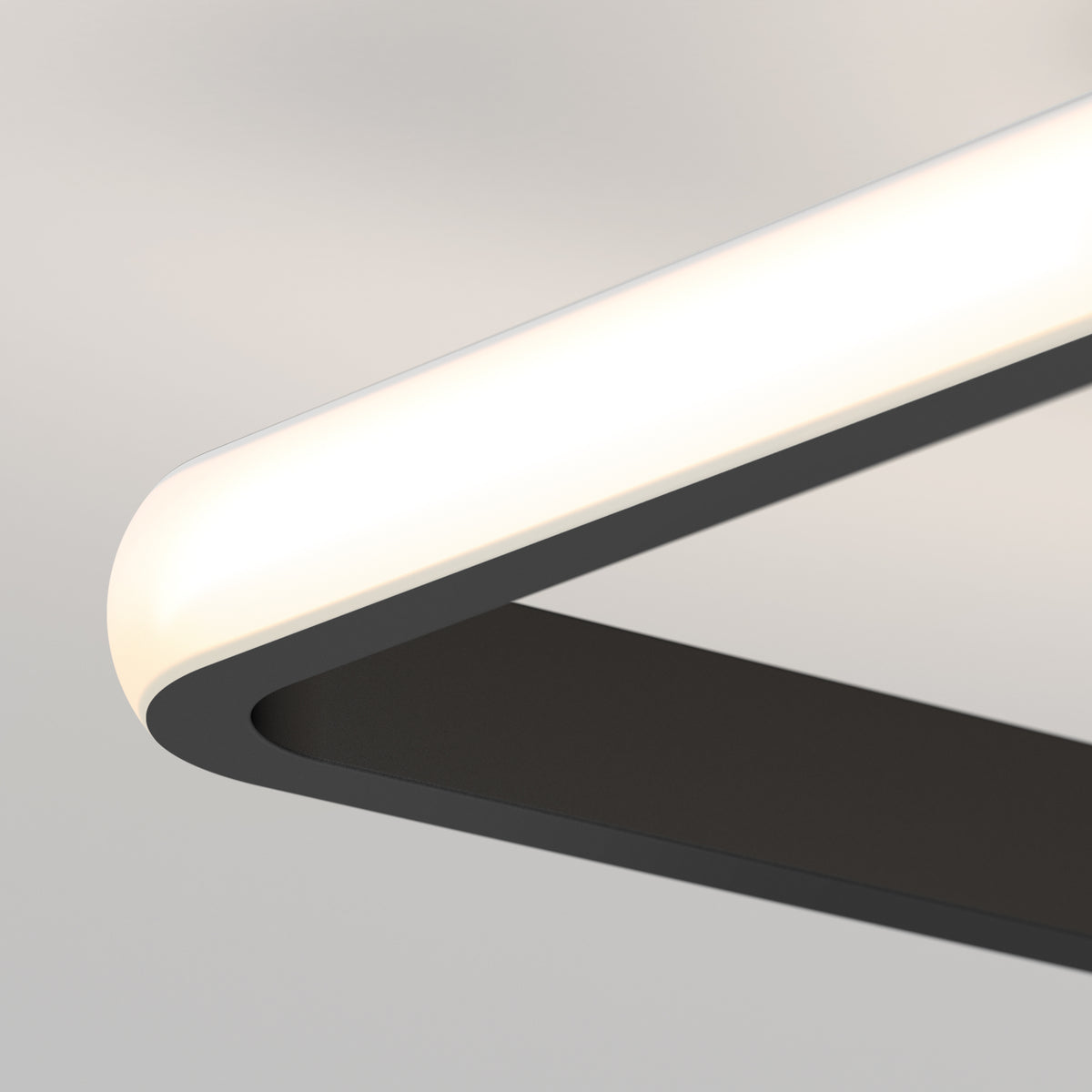 Close-up of the Artika Romeson 11 in. LED modern flush mount light (5 CCT), featuring a sleek black frame with rounded corners and a glowing white edge, set against a light gray background.