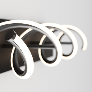A close-up of the Artika DNA modern LED bathroom vanity light with glowing curved arms on a black base against a white background.