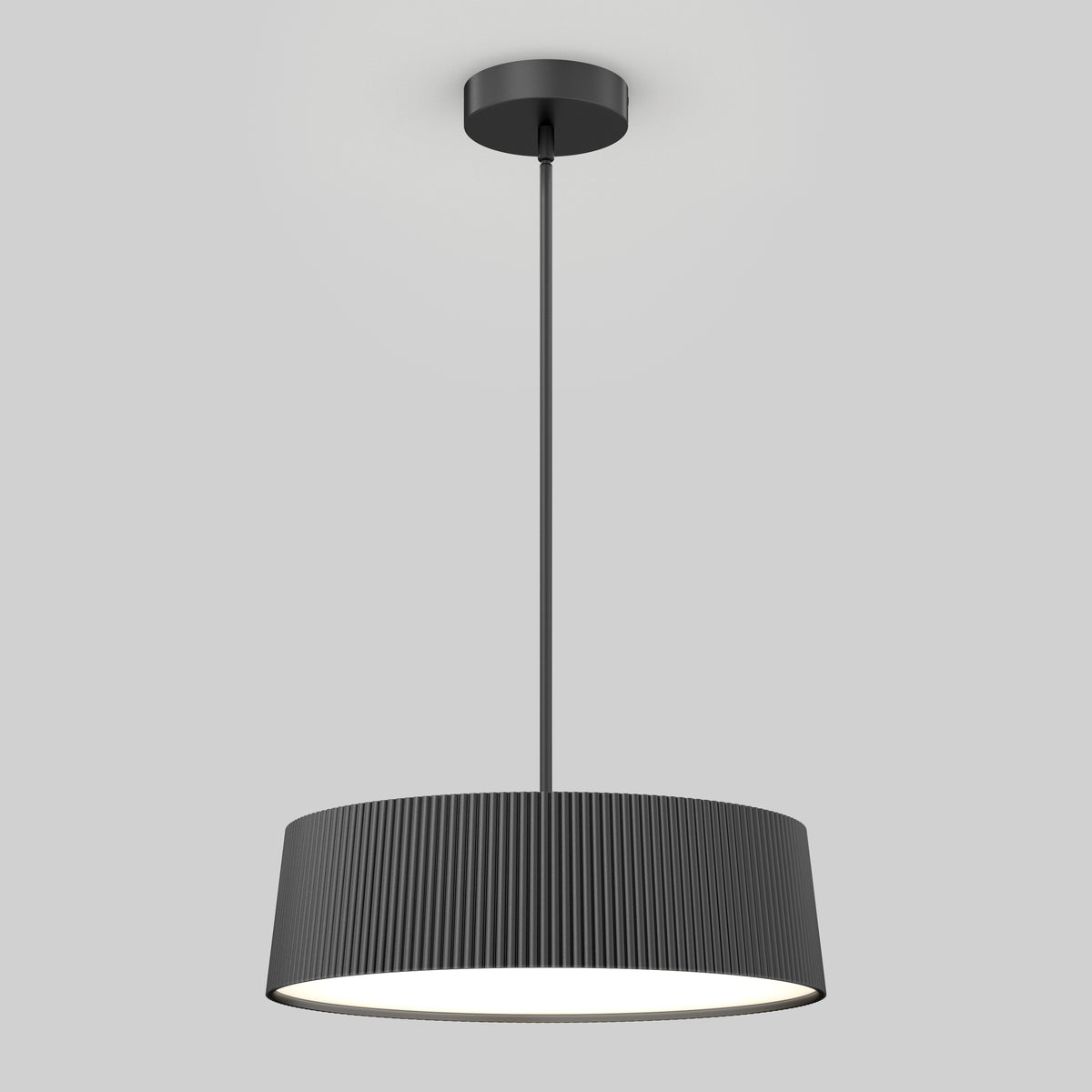 A modern black pendant light fixture with a ribbed cylindrical shade, suspended from the ceiling by a straight rod, is illuminated against a plain light gray background.