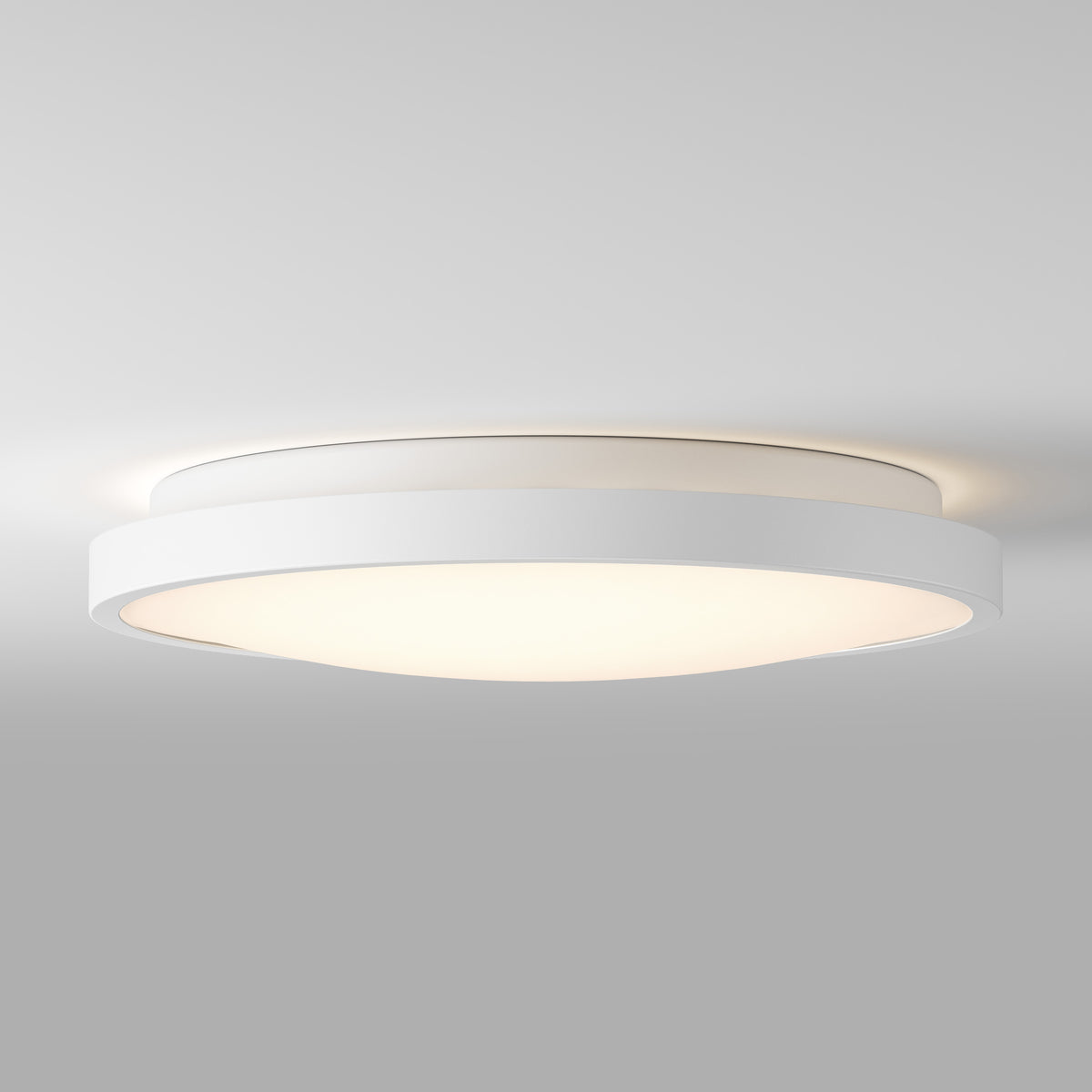 Artika Isara 12 in. RGBIC LED flush mount with interchangeable trim softly lights up a plain gray ceiling with modern, minimal style.