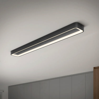 The Artika Aiden 48 in. LED modern flush mount light with a black frame is installed on a white ceiling above gray cabinets, offering customizable 5 CCT lighting.