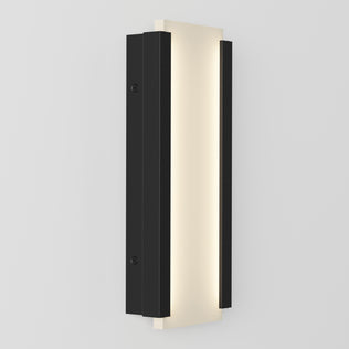 The Artika Blade indoor-outdoor LED wall light features a modern rectangular vertical design with a central frosted panel and two black metal side panels, shown mounted on a light-colored wall.