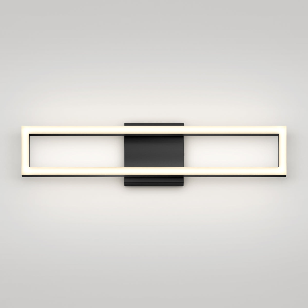 A modern wall sconce with a rectangular, open-frame LED light in a horizontal orientation, mounted on a black square base against a plain light-colored wall.