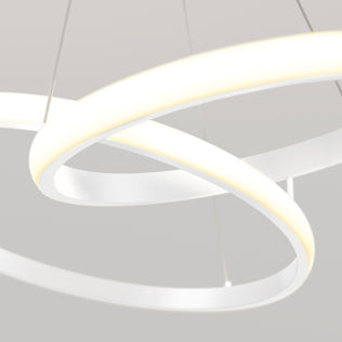 A close-up of the Artika Mora 28" LED Pendant, 5CCT showcases its modern circular design with overlapping white rings, suspended by thin cables against a light grey background.