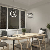 A modern dining area with a wooden table, four cushioned chairs, two geometric pendant lights, a potted plant, and large windows showing a sunset view outside. Decorative pillows and tableware are on the table.
