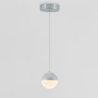 The Artika Sparkle 1 light LED pendant features a round shade with a half-metallic silver and half-glowing white design, suspended by a thin cord from a circular ceiling mount against a plain background.