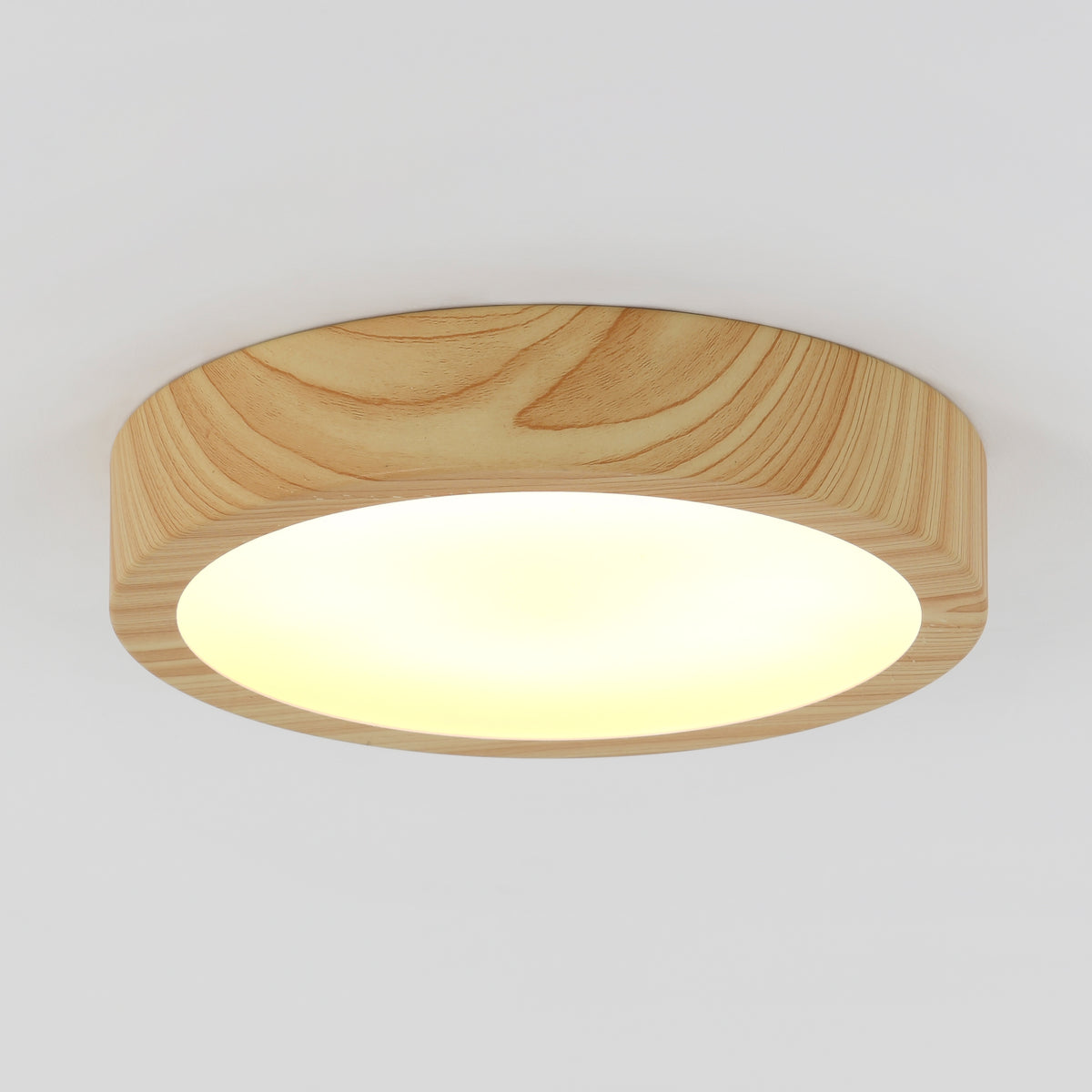 The Artika Dryad 10 in. Modern LED Flush Mount Ceiling Light softly illuminates a plain white ceiling with its sleek, minimalist design.