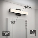 Rectangular LED vanity light with a matte black finish is mounted above a bathroom mirror. Text highlights its energy efficiency, matte black finish, integrated LED, and 3-year warranty.