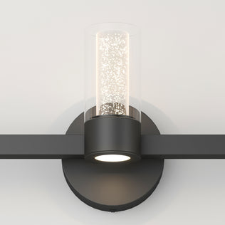 The Novello modern LED bathroom vanity light by Artika features a sleek black base and cylindrical glass shade.