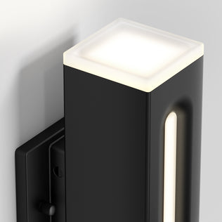 The Artika Linea Square LED indoor-outdoor wall light 3 CCT features a black rectangular body, illuminated top, and vertical glowing side strip, shown mounted on a light gray wall.
