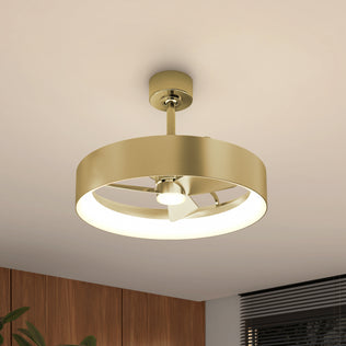 The Artika Austin 23 in. LED modern ceiling fan features a gold circular frame, integrated light, quiet motor, and three blades. It is mounted on a white ceiling in a contemporary room with wood paneling and window blinds.
