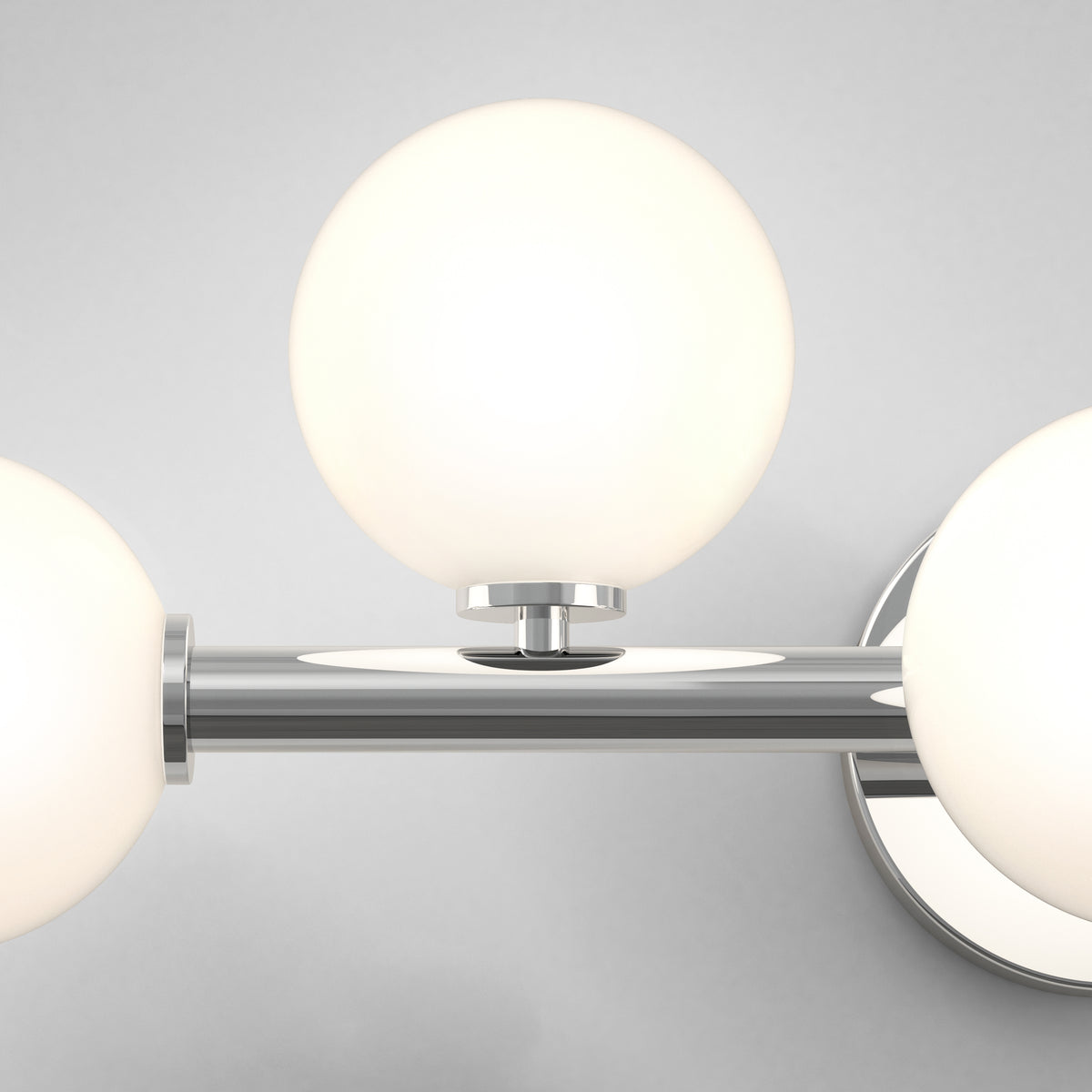 Close-up of the Artika Bloom 27-in (69 cm) 3-Light Modern LED Vanity Light for Bathroom, featuring three frosted glass globes and a chrome base—perfect for stylish bathroom lighting.