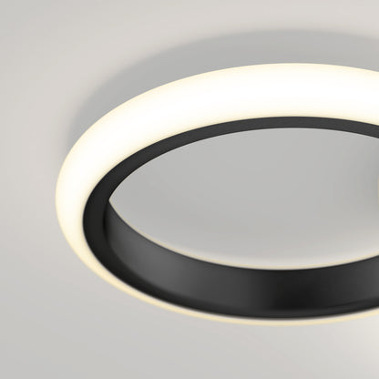 A close-up of the Artika Nyala 15 in. LED flush mount light 5CCT, featuring a black ring and glowing white edge, installed on a light-colored ceiling.