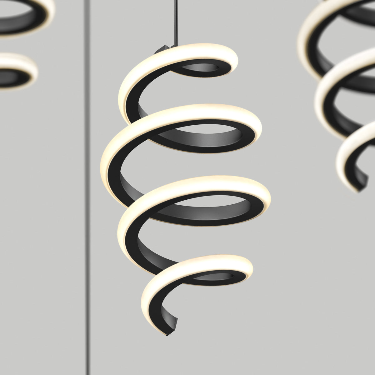 A modern pendant light fixture with a black spiral design and integrated LED lighting, suspended from the ceiling against a plain, light gray background. Additional similar fixtures are partially visible.
