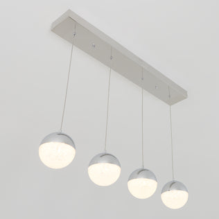 The Artika Sparkle 4-light LED pendant features four spherical lights suspended by thin wires from a sleek rectangular metallic base, offering bright white illumination in a modern design.