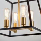 Close-up of a modern light fixture with exposed filament bulbs, gold sockets, and a black geometric metal frame against a neutral background.