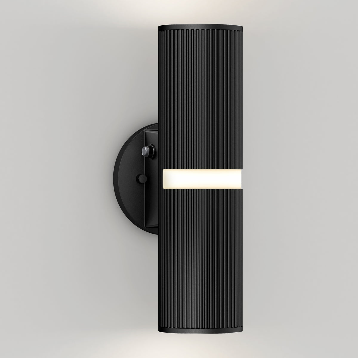 The Artika Groove LED indoor-outdoor wall light features a modern black design with vertical ridges on a round base, casting soft white light above and below from a central horizontal strip against a light-colored wall.